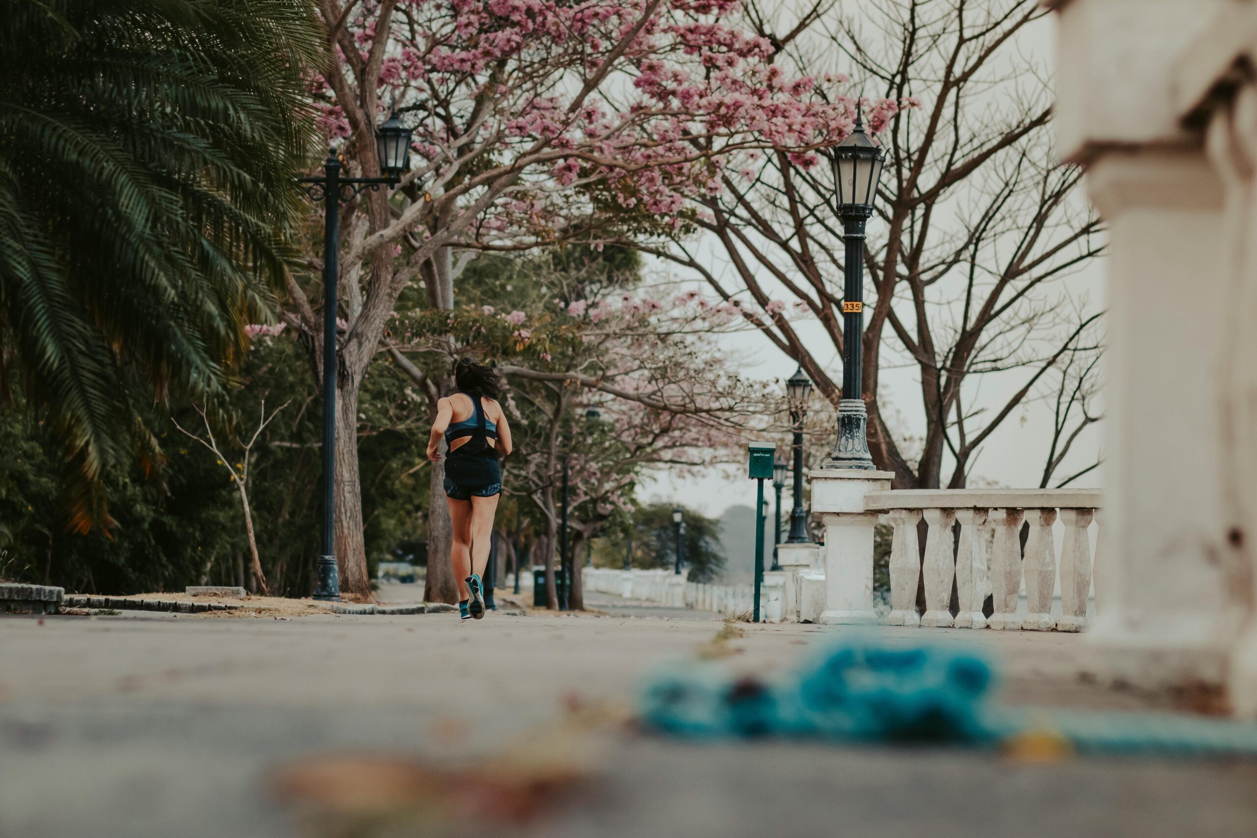 Beginner runner jogging on a suburban sidewalk at sunrise