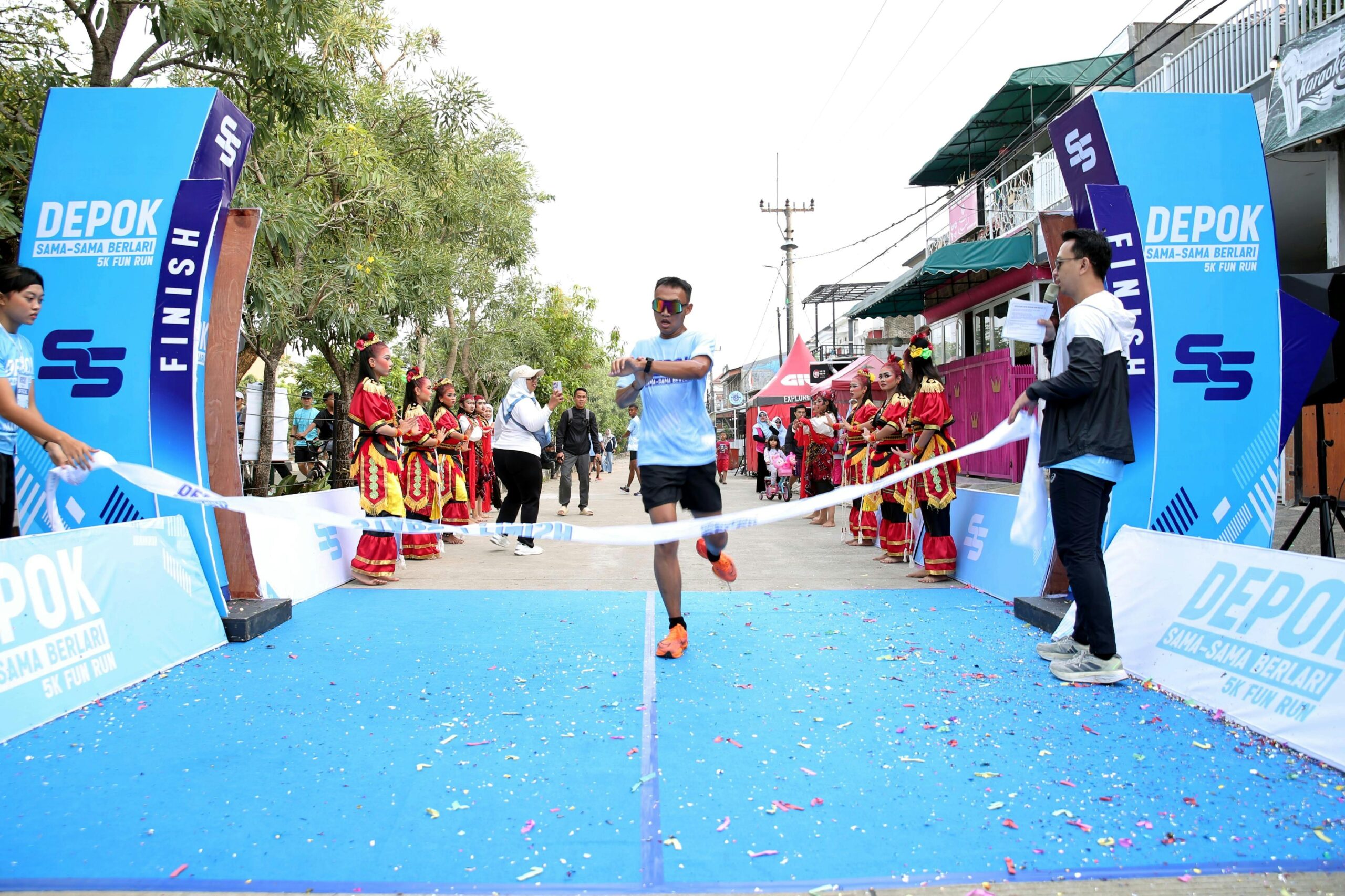 Runners crossing the finish line at a community 5K race